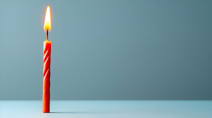 Single Lit Red Birthday Candle on Blue Background