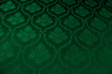Closeup of green victorian vintage textured textile wall