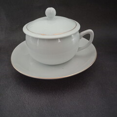 A hot tea in a white cup