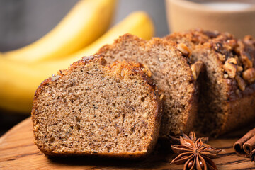 Banana bread with walnuts and cinnamon cut into slices. Slice of banana bread, closeup view
