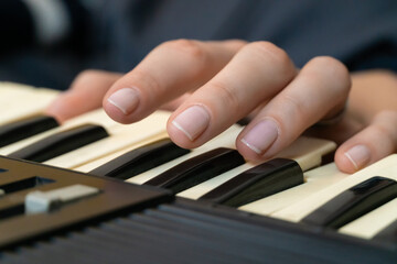 Fototapeta premium Fingers dancing over the keys of a vintage synthesizer, creating intricate melodies and rich electronic sounds, showcasing the skill and passion of a dedicated musician