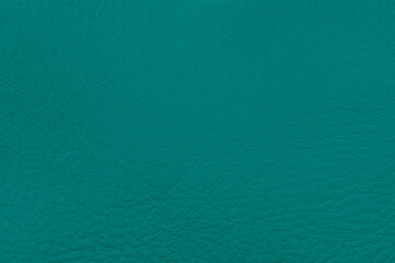 Textured teal leather surface, rich color, subtle grain patterns, detail in clean, minimalistic background for design