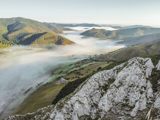 Misty Morning in the Romanian Mountains – Aerial View of Foggy Hills and Rocky Cliffs