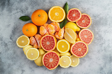Bright composition with oranges, lemons and grapefruits cut into slices
