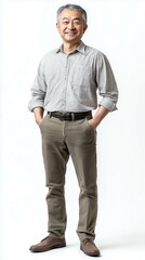 Fototapeta premium A confident middle-aged man posing in casual attire with a friendly smile on a clean backdrop.