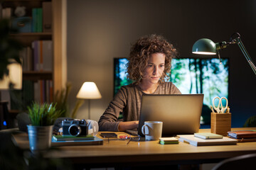 Young woman working on her laptop at home