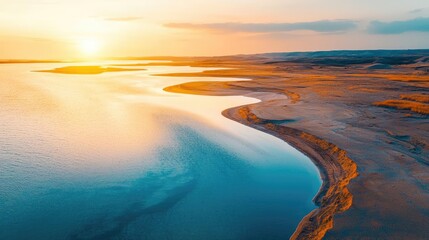 Fototapeta premium Weathering process idea. A serene river bends through the sandy shore under a vibrant sunset sky.