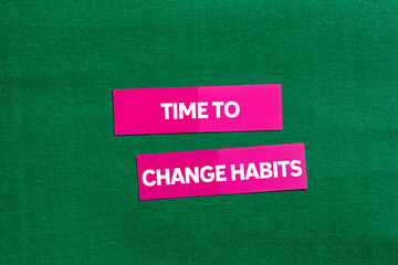 Time to change habits message written on pink stickers on green background. Conceptual time to change habits symbol. Copy space.