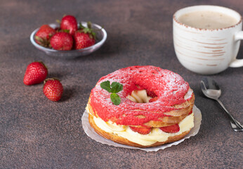 French cake Paris-Brest made from choux pastry, strawberry and custard