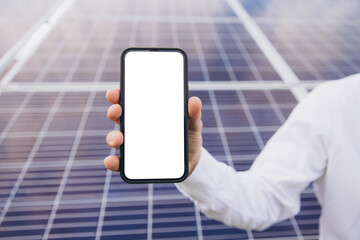 Hands showing blank screen mobile phone by pointing finger in front of solar panel - concept of application promotion, booking service and advertisement showing with copy space.