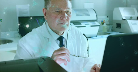 Image of data processing over caucasian male scientist in laboratory