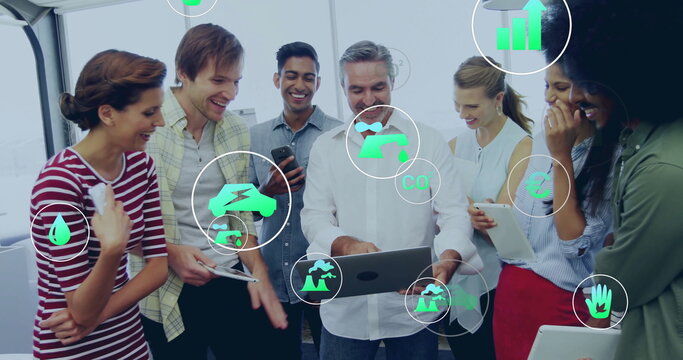 Image of eco icons and data processing over diverse business people in office