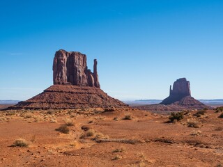 Majestic view of Monument Valley's iconic sandstone buttes under a clear blue sky.