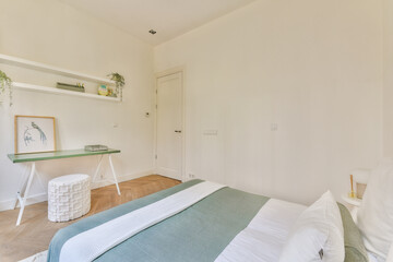 This minimalist bedroom showcases a light color palette, simple furnishings, and an uncluttered layout, designed for comfort and tranquility.