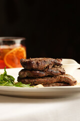Steak, salad, and cocktail on a restaurant table. Delicious meal, fine dining, food photography....