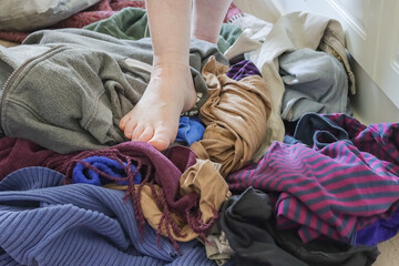 The floor is full of stuff. Hoarder can't clean anymore and walks around on clothes. She has too much of everything. Compulsive hoarding is a big problem for many.  © Aila Ruoho