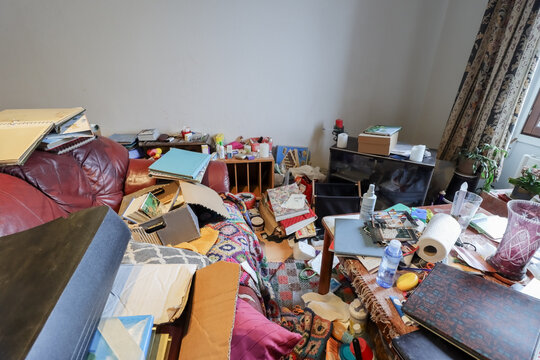 Hoarder's living room is a totally mess. Cleaning up a this kind of home is usually overwhelming. Stuff accumulates when the owner of the apartment don't want to give up anything, even trash.