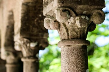 Intricate stone column detail with natural backdrop.