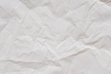 A sheet of white wrinkled glossy paper texture as background