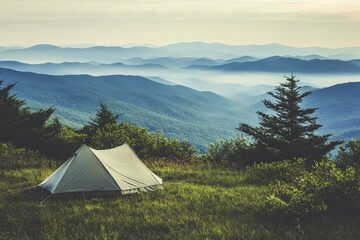 Obraz premium Tent set up on a hilltop with stunning mountain views during early morning light. Generative AI