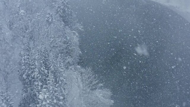 スーパースロー映像：ドローンで空撮した、大雪の日の川の上の風景