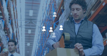 Image of media icons over caucasian male workers working in warehouse