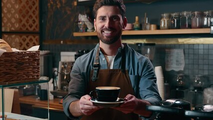Smiling cheerful Caucasian male small business owner man cafe barista in uniform holding cappuccino cup worker employer giving coffee to client guy serving order staff working in cafeteria catering