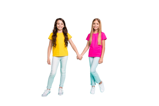 Full length body size photo of two nice cute beautiful kind friendly girls holding each other hands while isolated with teal background