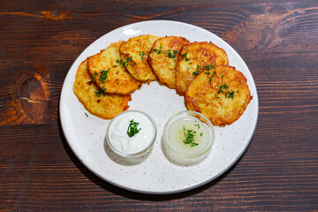 Delicious potato pancakes served with sour cream and sauce