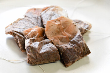 Used tea bags on a plate. 