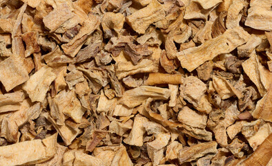 A close-up of dried vegetable pieces, including onion, beetroot, and carrot. The mix for soups and seasonings