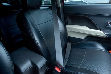 A car seat belt installed in the front seat of the car. Fastened seat belt.
