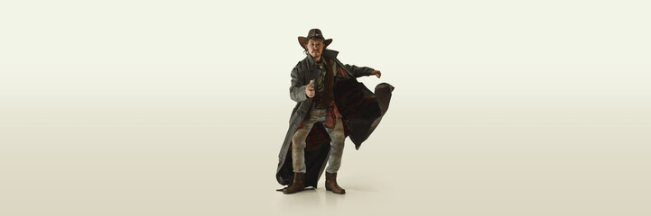 Man, cowboy in long leather coat dynamically drawing gun, coat flowing in movement, determined...