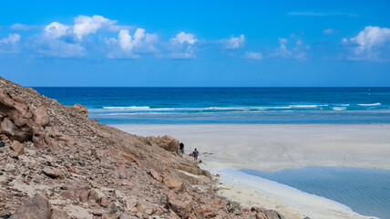 Vibrant coastal landscape in Socotra with rocky terrain and sandy beaches under clear blue sky