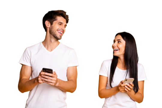 Photo of two people holding telephones checking feednews laughing about good joke wear casual clothes isolated yellow color background