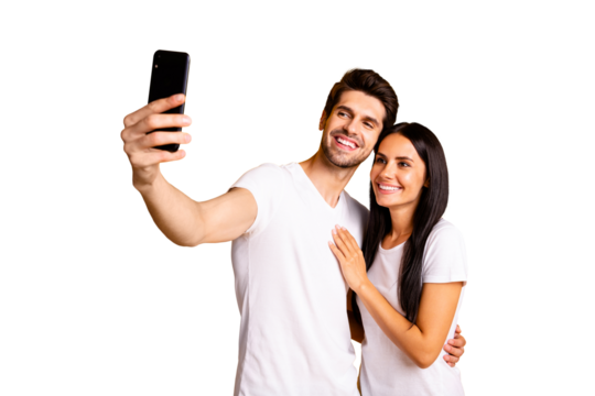 Photo of two people holding telephone in hand taking selfies for new post wear casual clothes isolated yellow color background