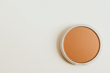 Fototapeta premium Minimalist design featuring round makeup compact with warm-toned