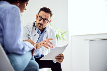 Doctor Discussing Medical Results With Concerned Patient in Bright Office Setting