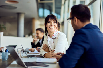 Professional Team Discussing Ideas in Modern Office Setting with Friendly Atmosphere