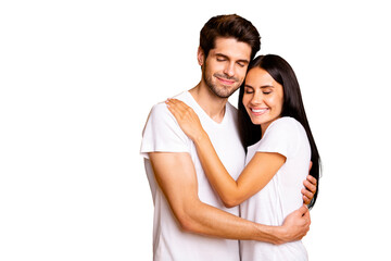 Fototapeta premium Photo of amazing pair in love holding each other in hands close eyes wear casual white t-shirts isolated yellow color background