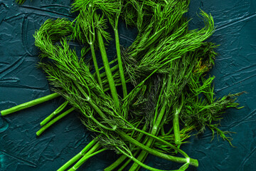 Wilted dill on a green or malachite background. Spoiled or low-quality products.