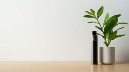 Vaping device on a light wood countertop with a small plant. Featuring clean lines and sleek design