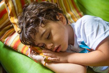 Four-year-old boy taking an afternoon nap after lunch