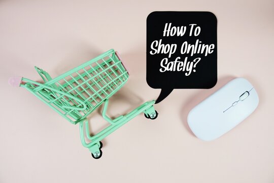 How To Shop Online Safely? text on speech bubble with optical mouse and trolley shopping cart on pink background