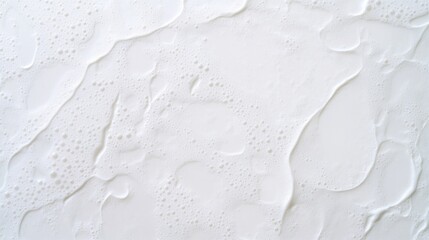 Smooth white surface features subtle textures and gentle undulat