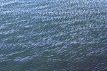 Blue water surface. Water background. Sea surface with small waves.