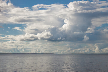 Cloudy Sky over Calm Ocean, Blue and Gray Tones, Tranquil Seascape