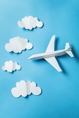 Paper Airplane in a Blue Sky with Clouds