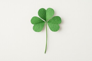 Green four leaf clover on a light background symbolizing good luck and prosperity, perfect for seasonal designs and nature themed projects
