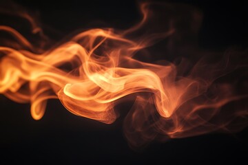 Abstract orange smoke swirls on black background.